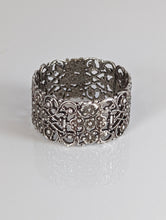 Load image into Gallery viewer, A silver filigree band ring with a detailed, intricate pattern.